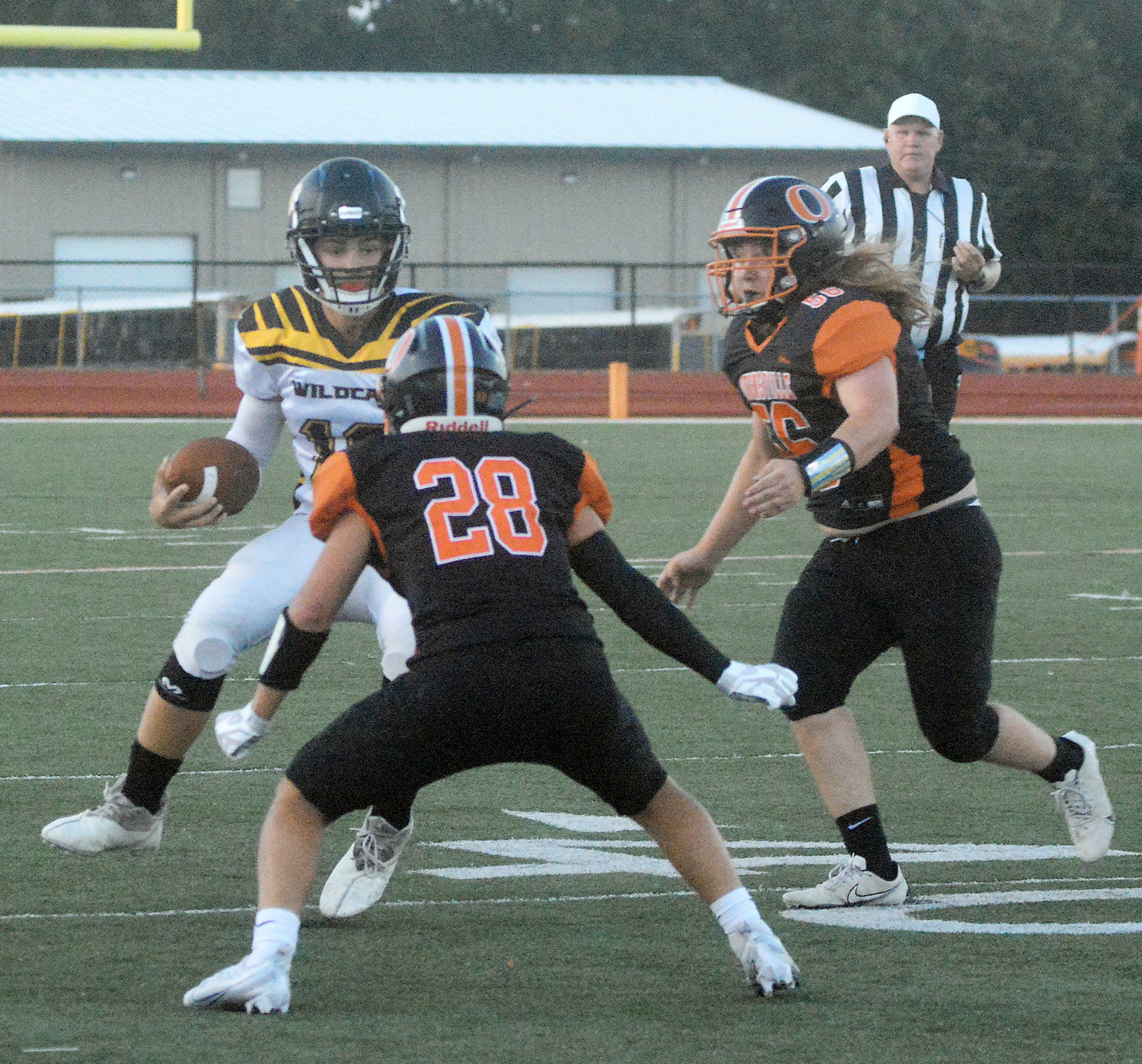 Brendon Stevens (far left) gets met by Dutchmen defenders Derrick Marquez (28) and Jacoby Limberg during Owensville’s 50-0 season-opening shutout of Cuba’s Wildcats Friday night at Dutchmen Field.